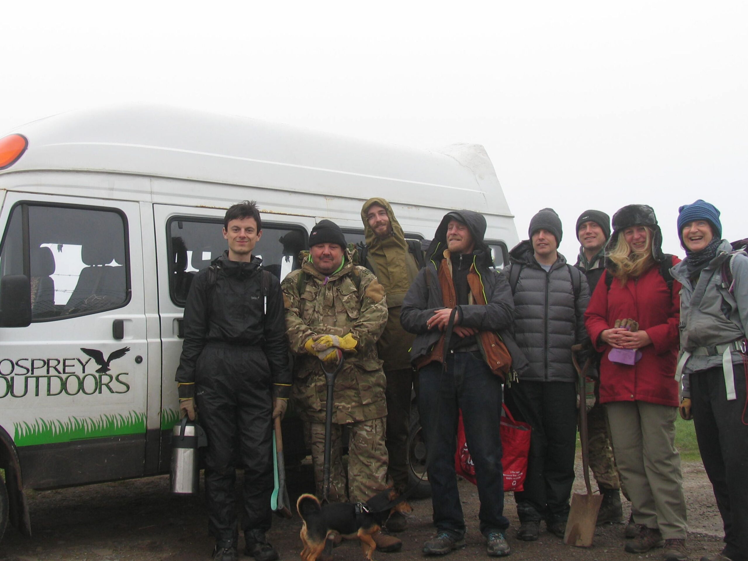 Group of people stood next to the Osprey minibus