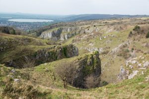 View from the top of the Gorge over rocky outcrops towards Cheddar reservoir