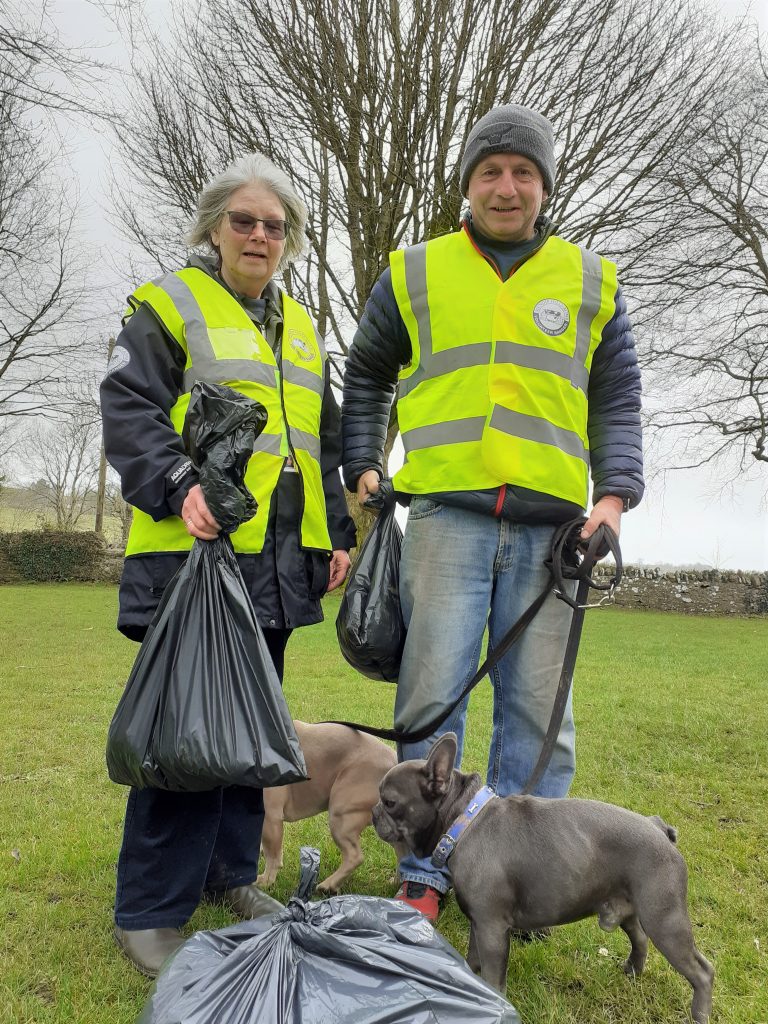 Volunteers with bags of litter they've collected